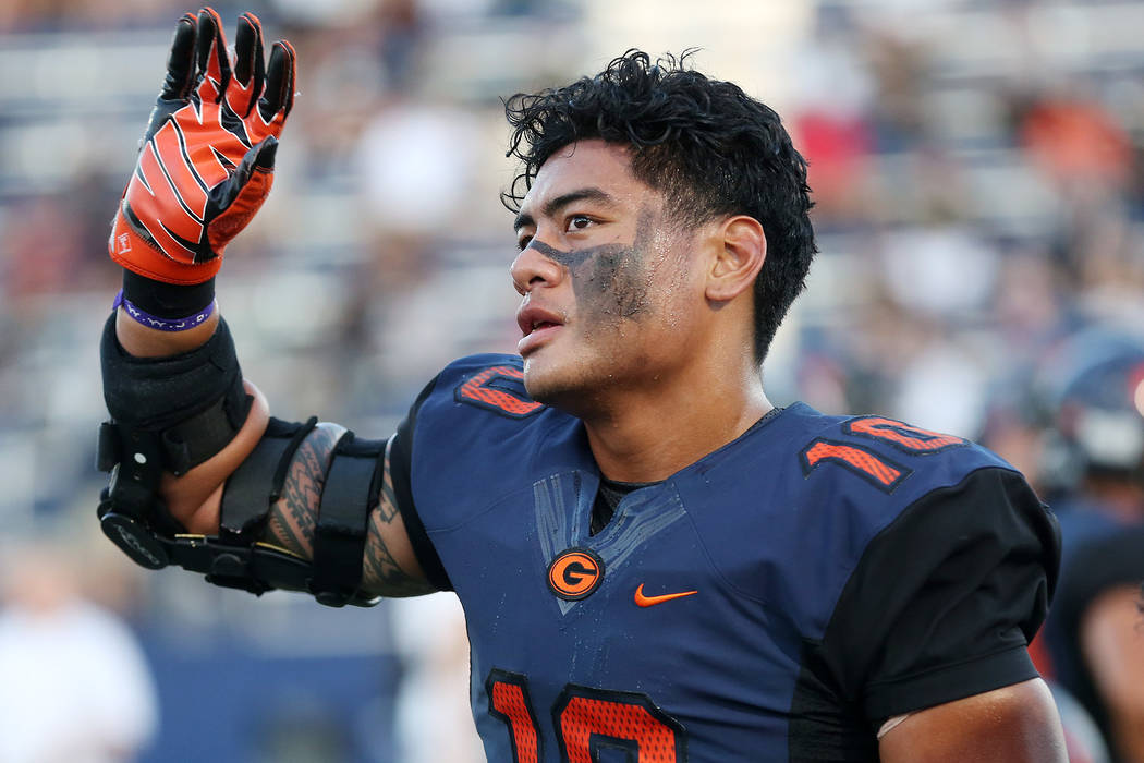 Bishop Gorman’s Palaie Gaoteote waves to the stands prior to the start of the game aga ...