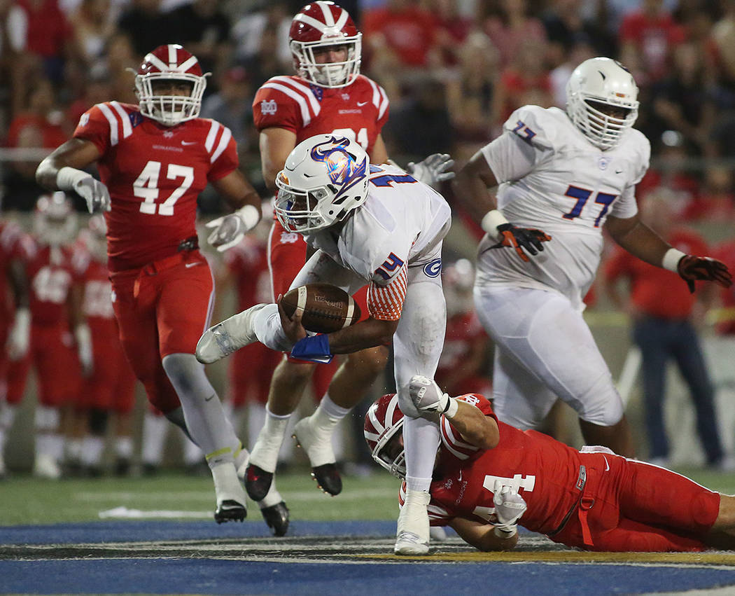 Bishop Gorman player Dorian Thompson-Robinson (14) is tackled by Mater Dei player Brandon La ...