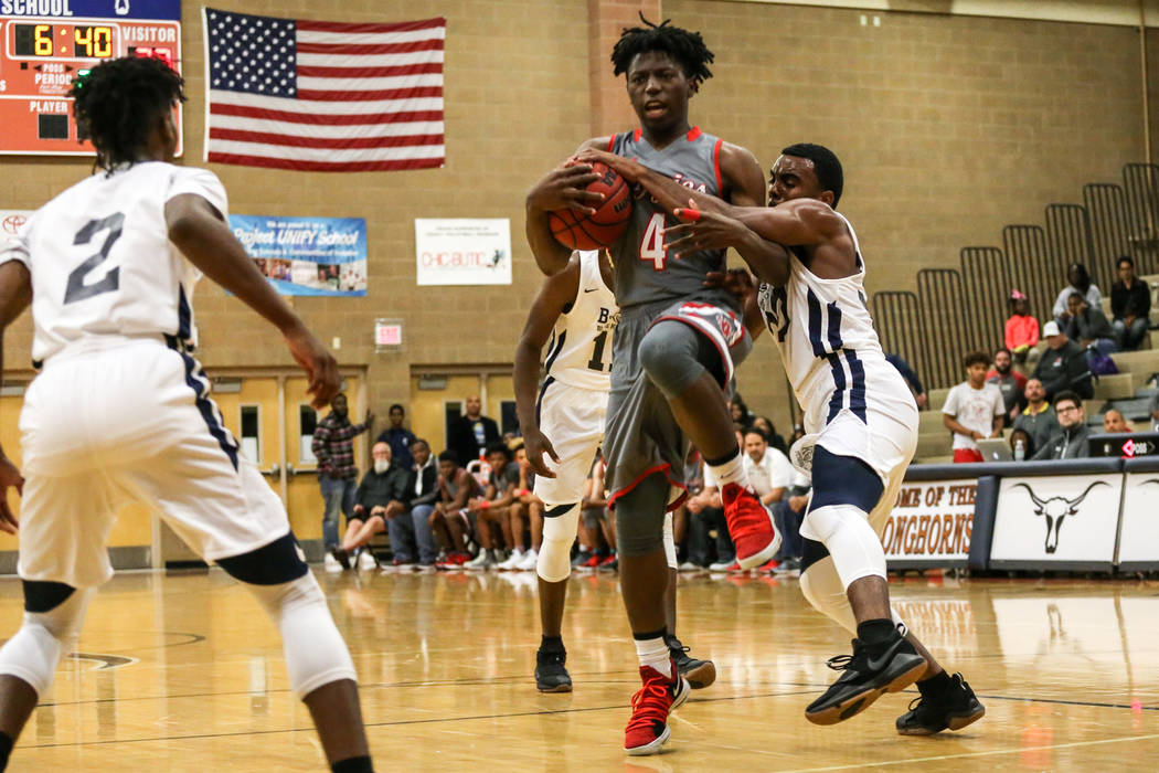 Arbor View’s Tyre Williams (4), center, is guarded by Democracy Prep’s Daniel Pl ...