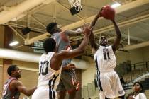 Democracy Prep’s Jared Holmes (11), right, receives a rebound against Arbor View durin ...