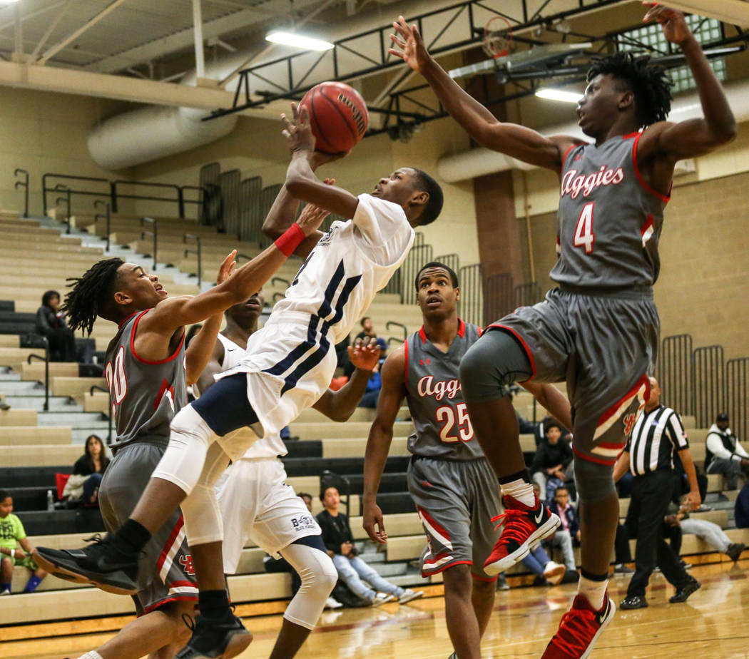Democracy Prep’s Najeeb Muhaamad (1), center, is fouled by Arbor View during the third ...