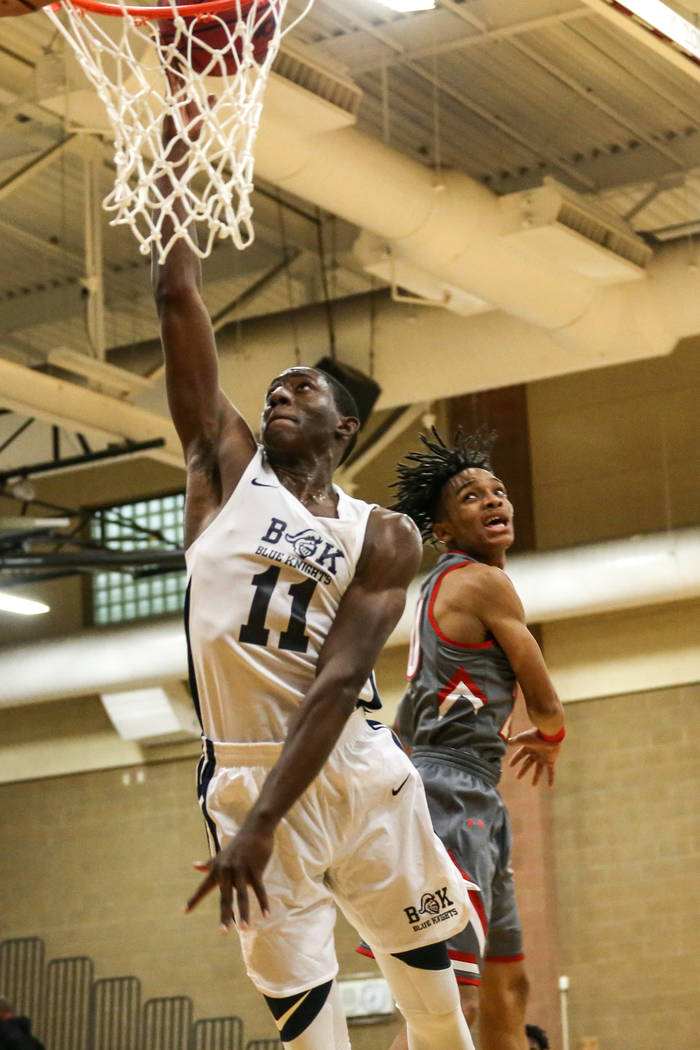 Democracy Prep’s Jared Holmes (11), left, scores against Arbor View during the fourth ...