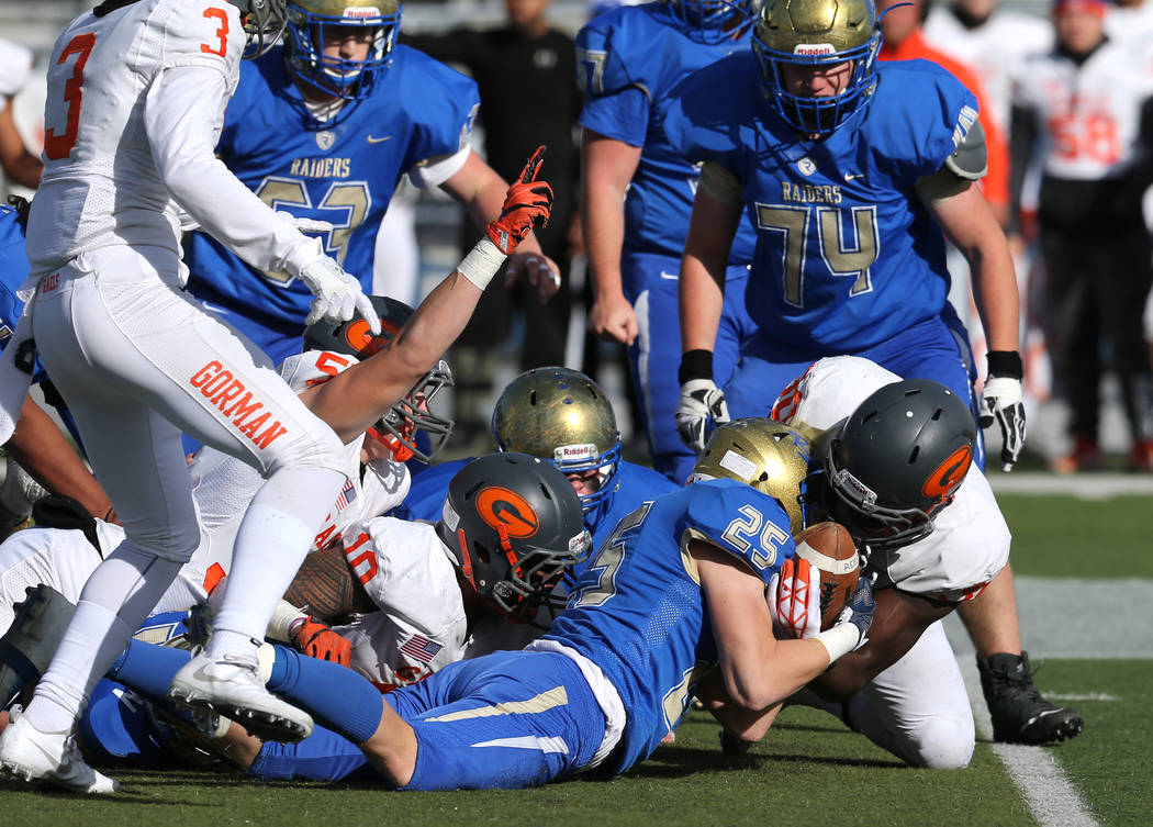 Bishop Gorman and Reed players fight for a loose ball during the first half of the NIAA 4A s ...