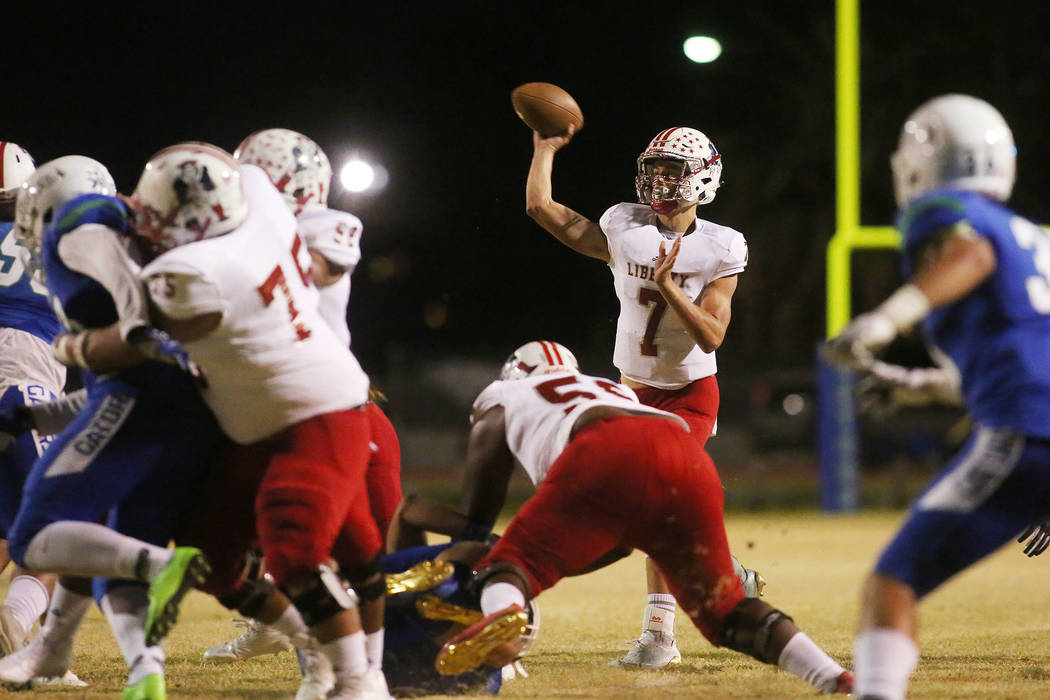 Liberty quarterback Kenyon Oblad (7) passes the ball during the first half of a game against ...