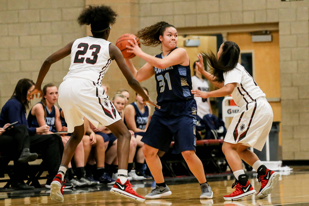 Foothill’s Bri Rosales (31), center, is guarded by Desert Oasis’ Desi-rae Young ...