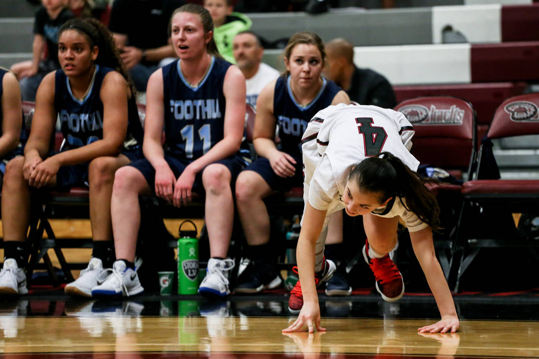 Desert Oasis’ Brianna Clark (4) pushes herself up after falling on the court during th ...