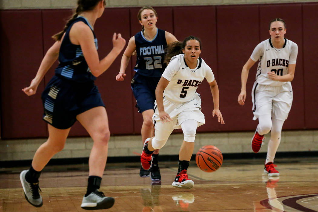 Desert Oasis’ Eliyjah Pricebrooks (5), second from right, dribbles the ball down court ...