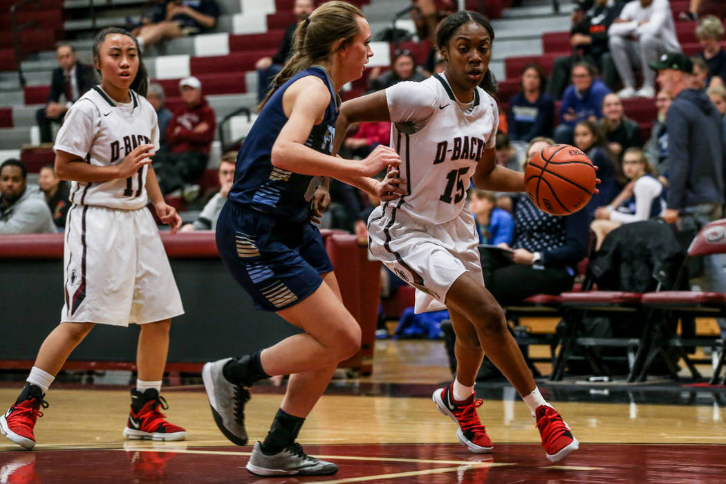 Desert Oasis’ Ahmaya Smith (15), right, dribbles the ball as she is guarded by Foothil ...