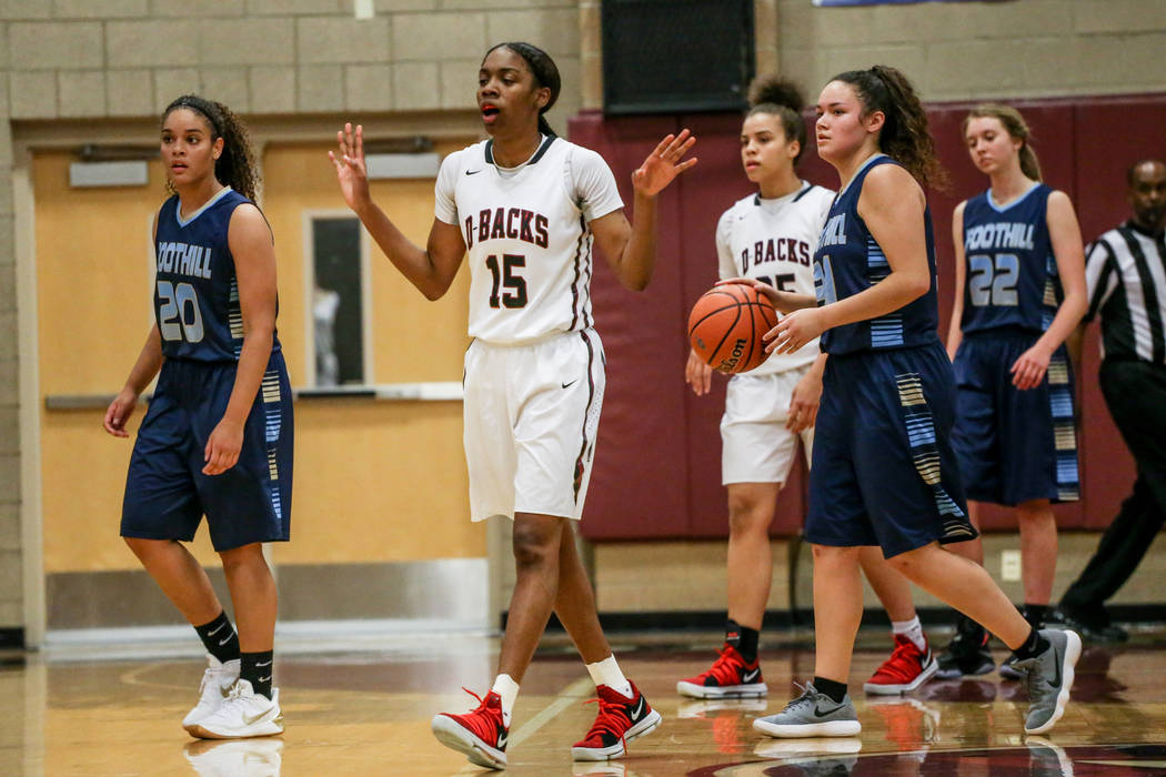 Desert Oasis’ Ahmaya Smith (15), second from left, reacts after a foul during the thir ...