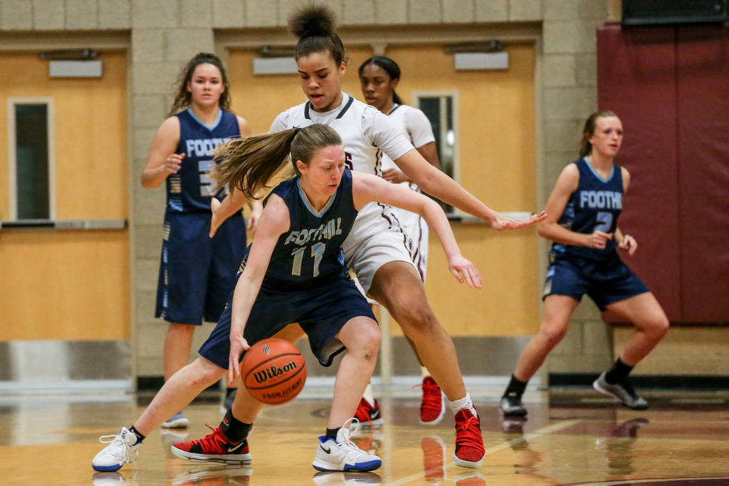 Foothill’s Kaylee Hall (11), left, dribbles the ball as she is guarded by Desert Oasis ...