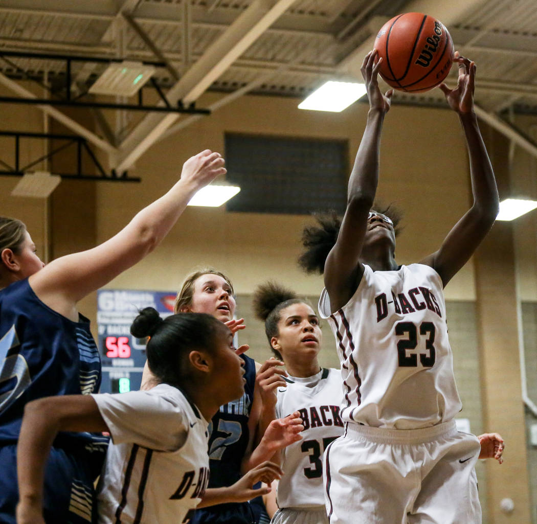 Desert Oasis’ Desi-rae Young (23), right, catches a rebound during the fourth quarter ...