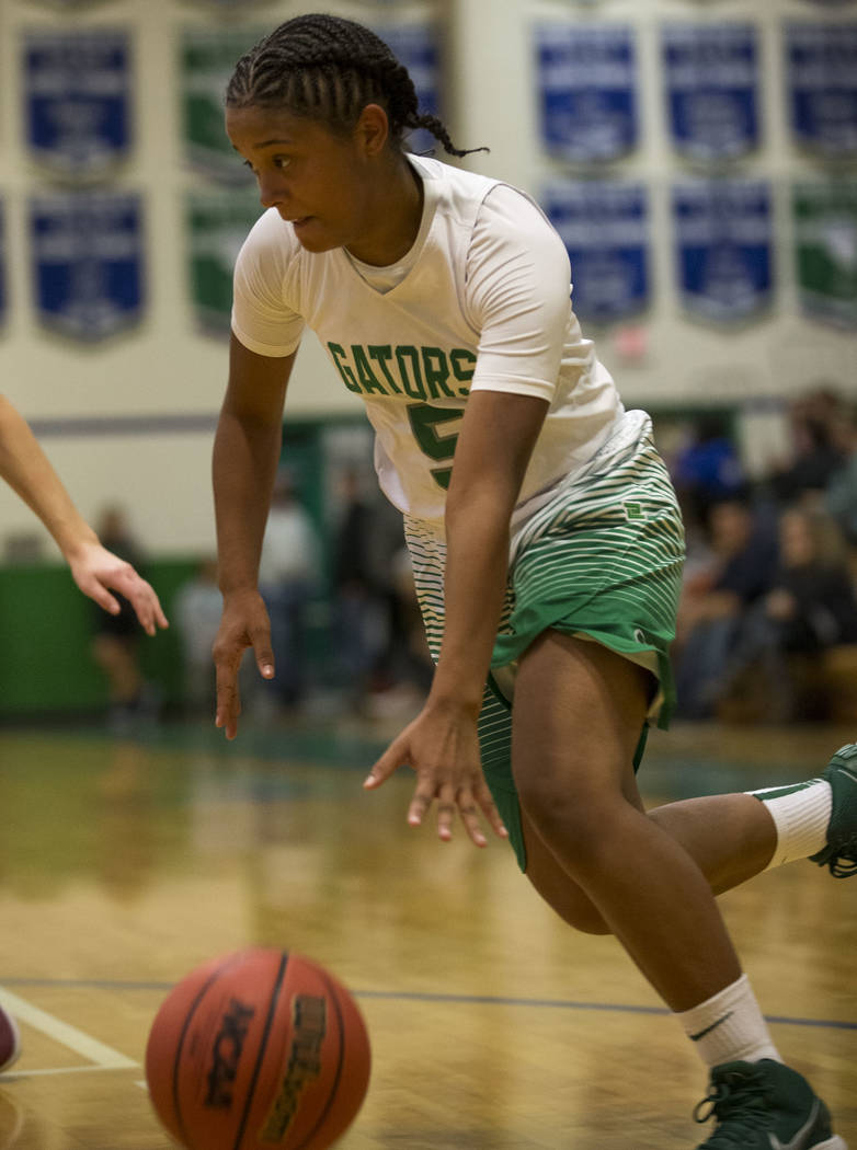 Green Valley junior Shelby Clark drives the ball against Faith Lutheran during a varsity bas ...