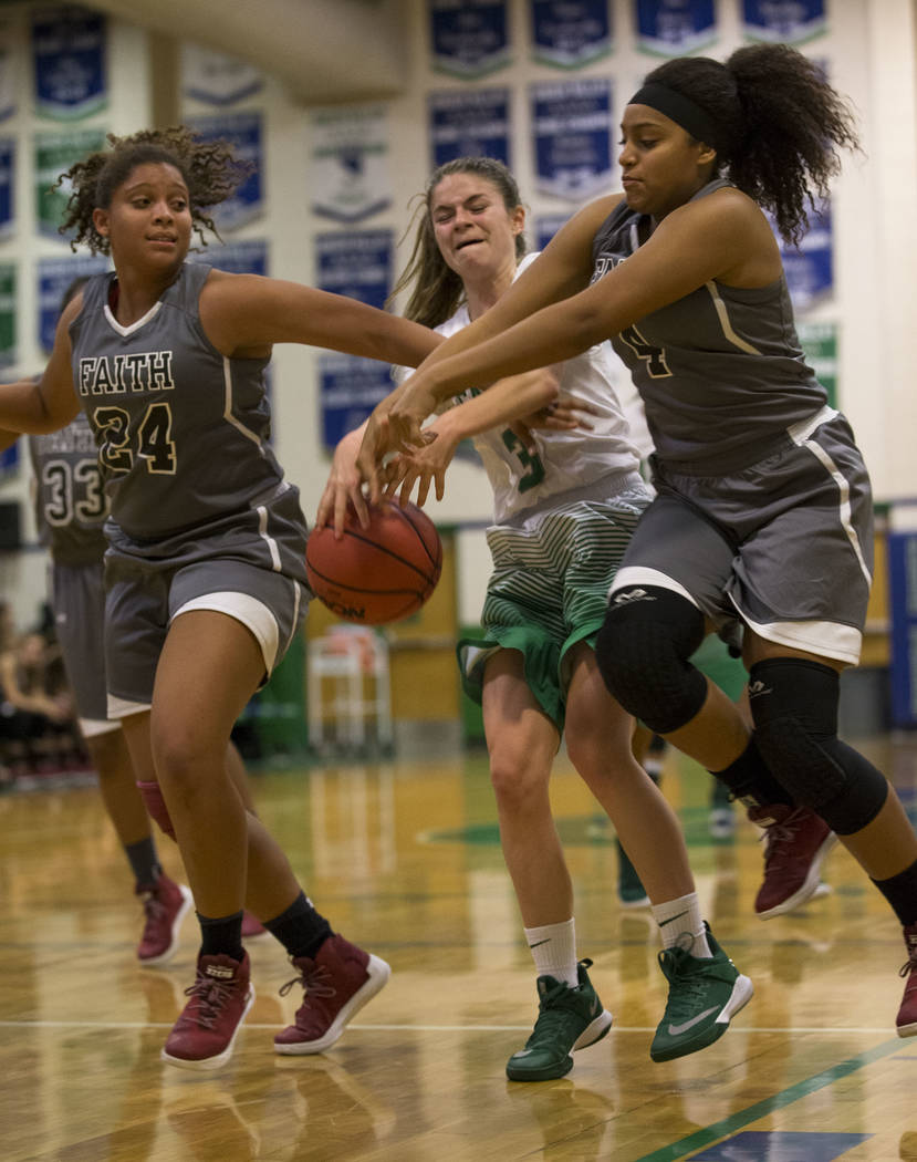 Faith Lutheran’s Kayla Proctor (24) and Casey Proctor (4) rip the ball away from Green ...