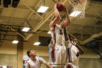 Desert Oasis’ Jacob Heese (15) receives a rebound during the first quarter of basketba ...