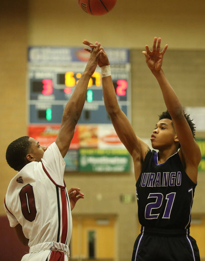 Desert Oasis player Kamari Burnside (0) attempts to block Durango player Anthony Hunte&#8217 ...