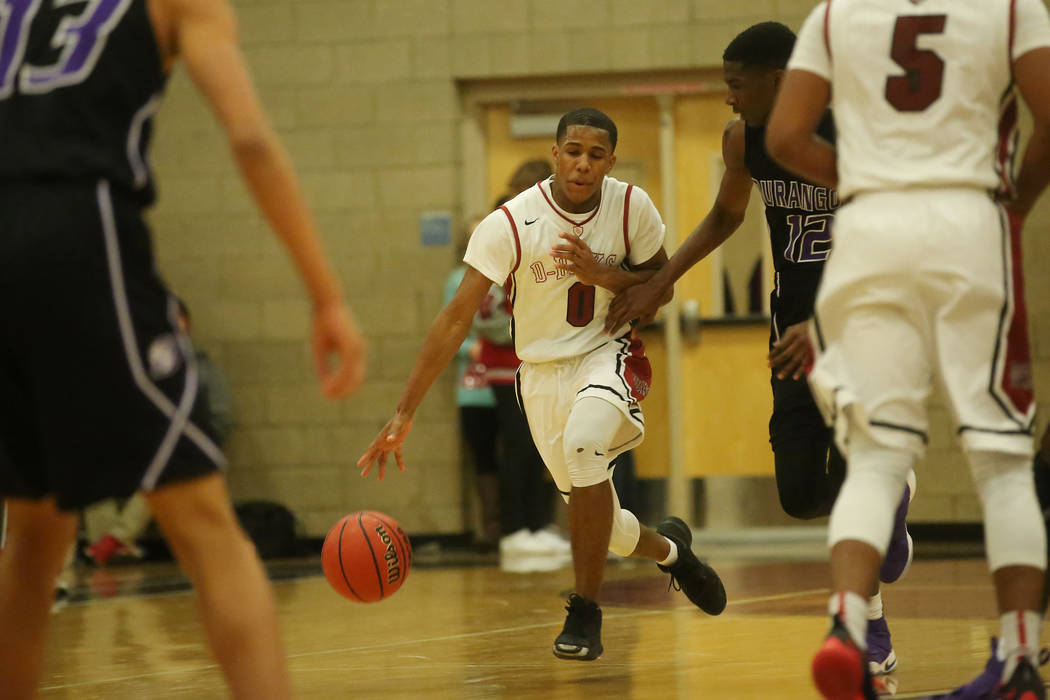 Desert Oasis player Kamari Burnside (0) brings the ball up the court during a game against D ...