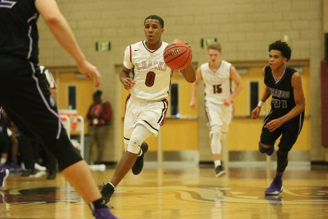Desert Oasis player Kamari Burnside (0) brings the ball up the court during a game against D ...