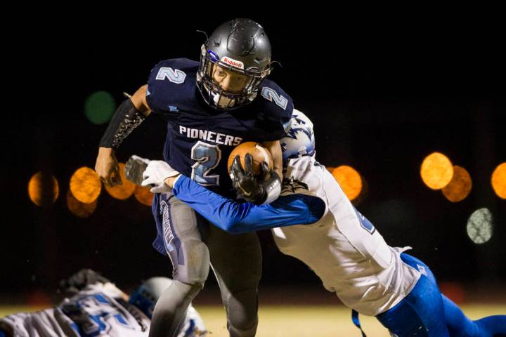 Canyon Spring’s DiaMante Burton (2) runs the ball against Basic’s Franco Mays (1 ...