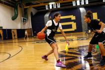 Essence Booker (3) dribbles the ball as she is guarded by a teammate during a basketball pra ...