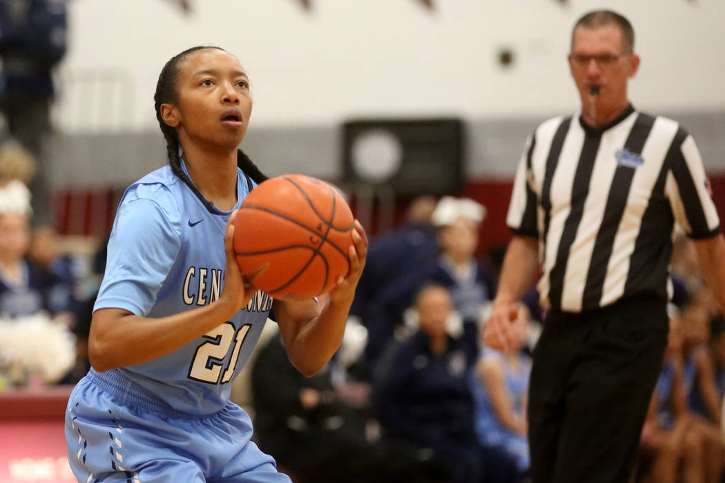 Centennial girls basketball player Justice Ethridge (21) prepares to shoot during a game aga ...