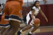Cimarron-Memorial’s Tasia Moore (32) looks for an open play against Legacy in the girl ...