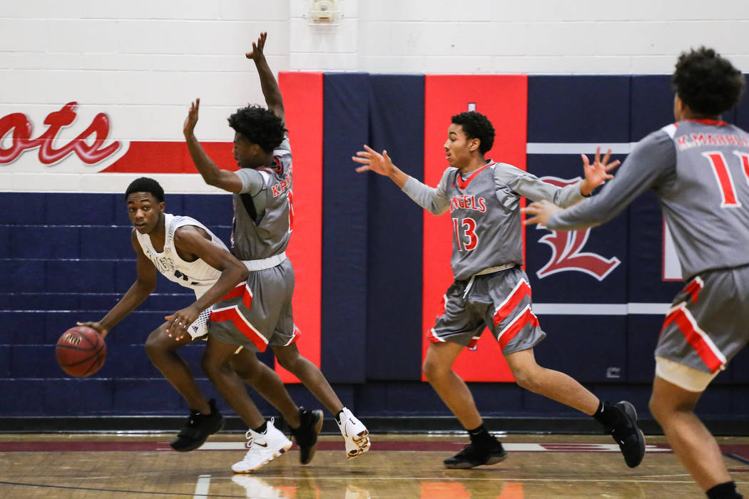 Desert Pines’ Dayshawn Wiley (2) is guarded by Denver East’s Kaelan Potts (1) du ...