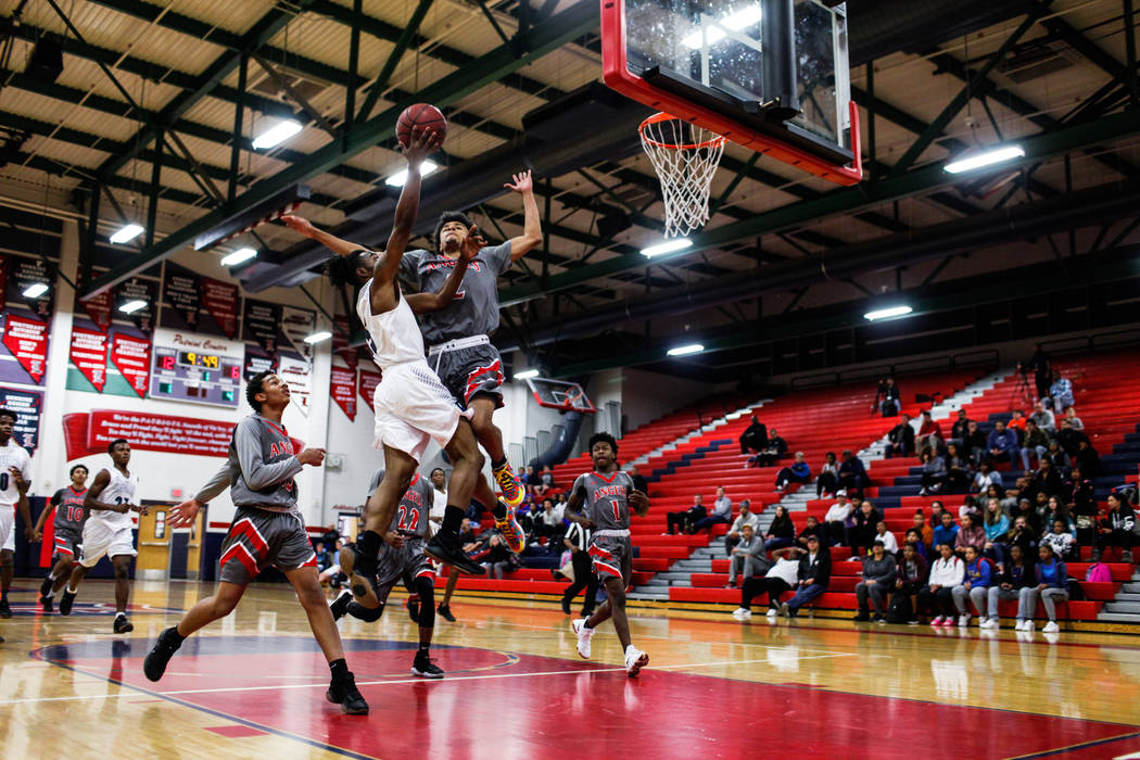 Desert Pines’ Zerrick Brass (35) is blocked by Denver East’s Daylen Kountz (2) d ...