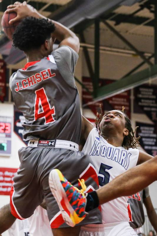 Denver East’ Ja’shawn Chisel (4) is guarded by Desert Pines’ Lorenzo Sheld ...