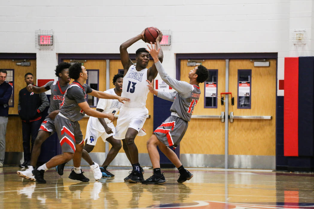 Desert Pines’ Darnell Washington (13) is guarded by Denver East’ Clayton Finley- ...