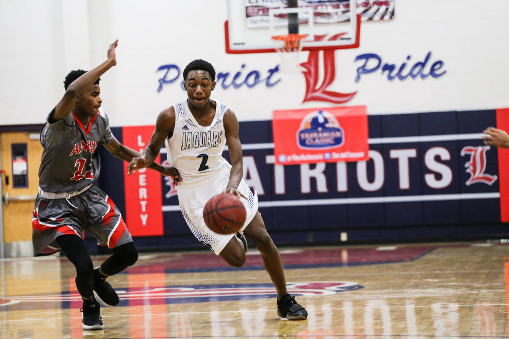 Denver East’s Caulin Swain (22) guards Desert Pines’ Dayshawn Wiley (2) during t ...