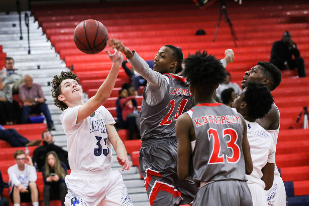 Desert Pines’ Garrett Partain (33) is blocked by Denver East’ Jamir Moore (24) d ...