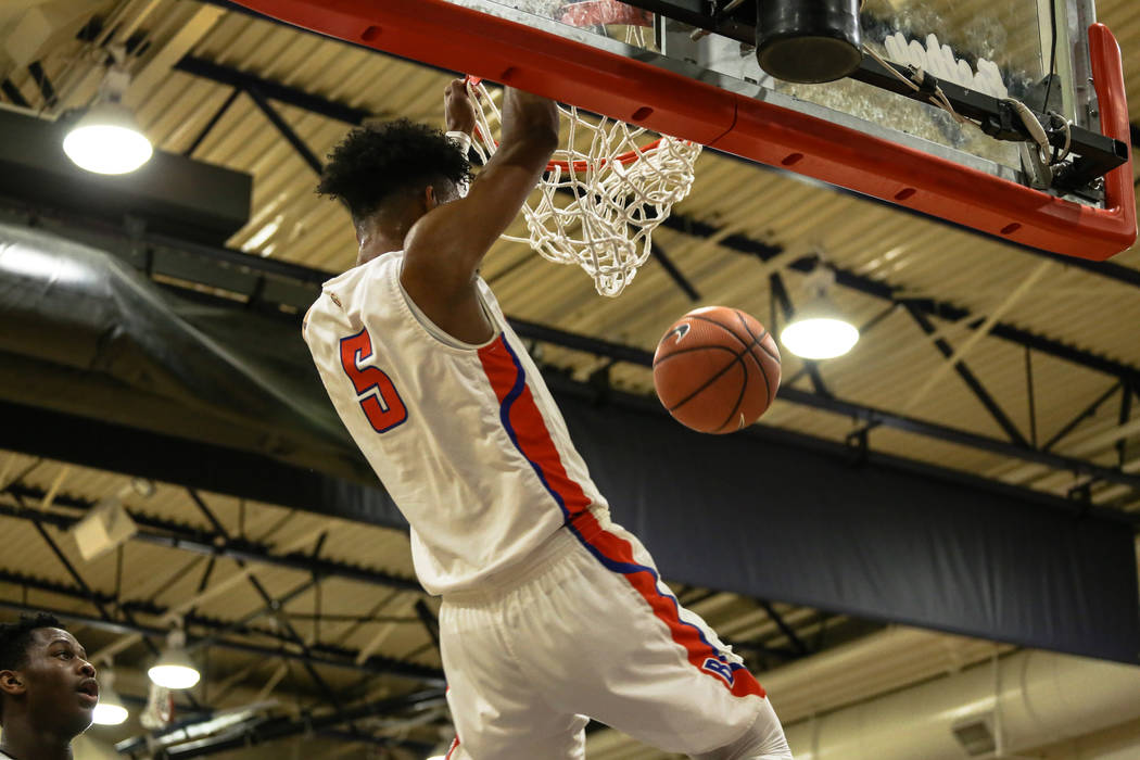 Bishop Gorman’s Jamal Bey (5) scores a slam dunk against the Clark Chargers during the ...