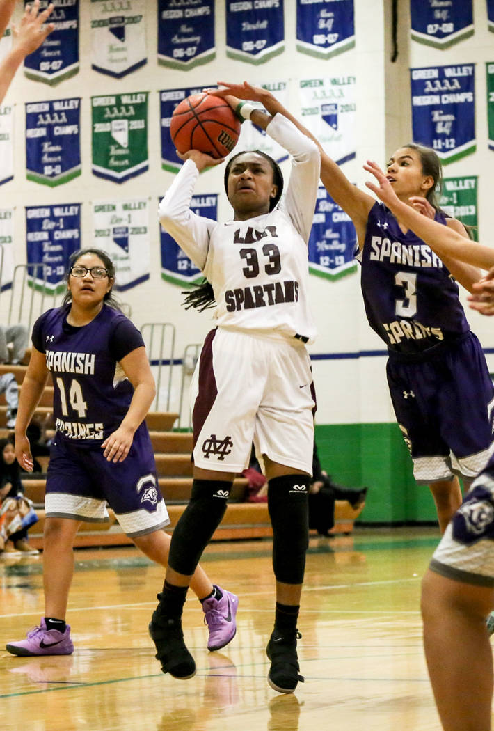 Cimarron-Memorial’s Amoura Whitney (33) shoots the ball Spanish Springs’ Jada To ...