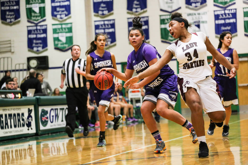 Spanish Springs’ Kierra Johnson (32) dribbles the ball as she is guarded by Cimarron-M ...