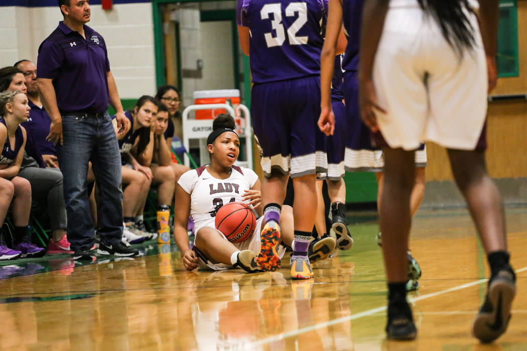 Cimarron-Memorial’s Tasia Moore (34) holds onto the ball after hitting the ground duri ...