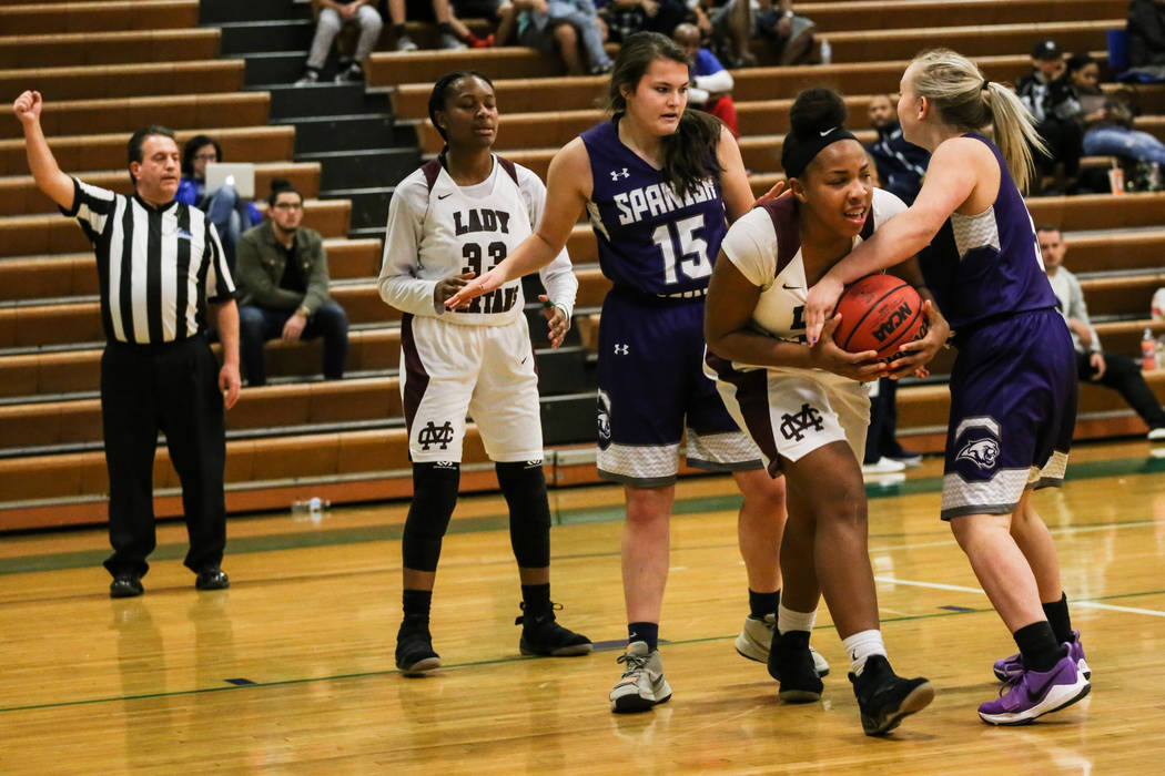 Cimarron-Memorial’s Tasia Moore (34), left, holds onto the ball as Spanish Springs&#82 ...