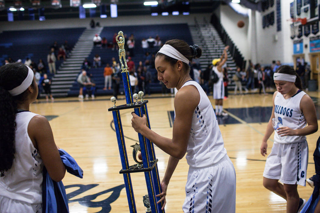 Centennial’s Jade Thomas (5) holds the championship trophy after defeating Etiwanda 59 ...