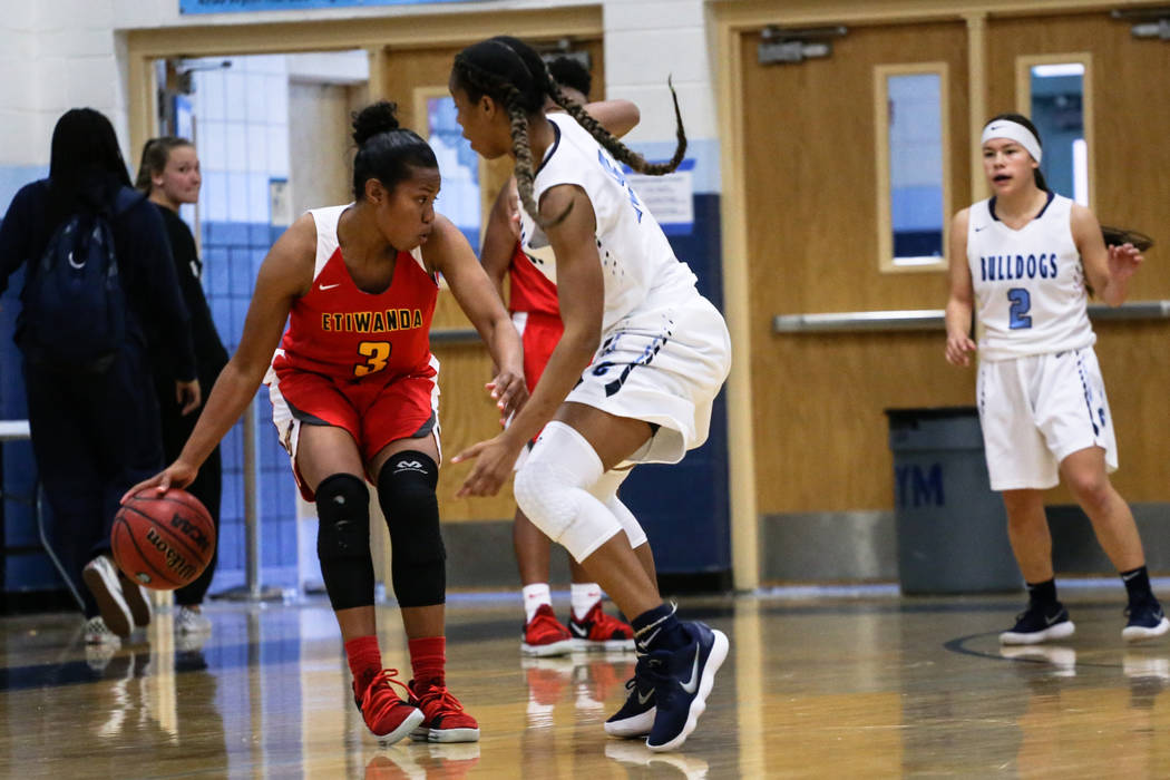 Etiwanda’s Evanne Turner (3) is guarded by Centennial’s Daejah Phillips (15) dur ...