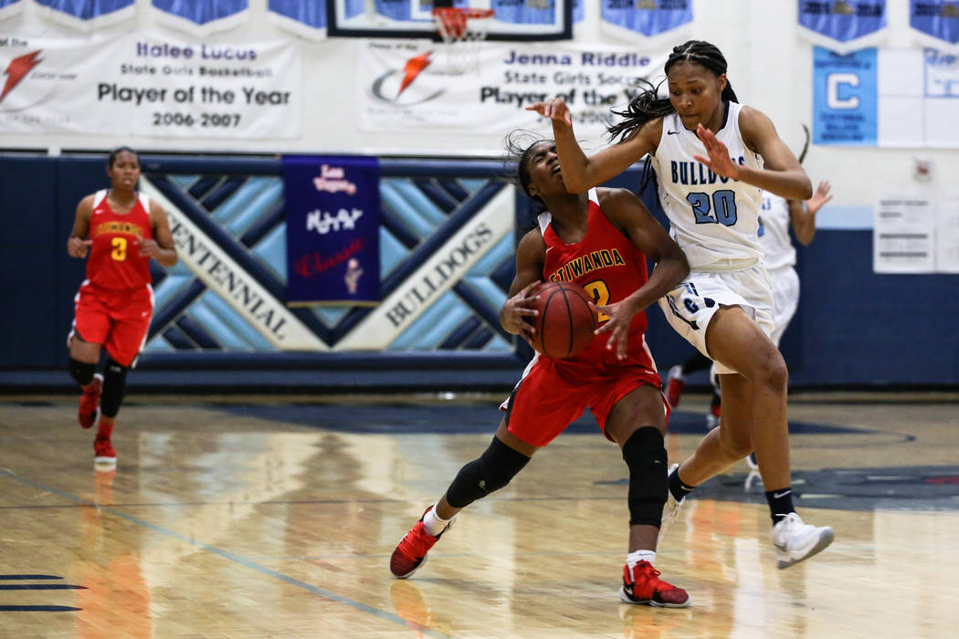 Etiwanda’s Aujane Mayes (2) is guarded by Centennial’s Taylor Bigby (20) during ...