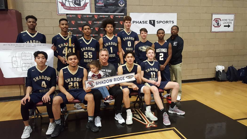 Shadow Ridge basketball players pose with their trophy at the Tri-State Invitational on Frid ...