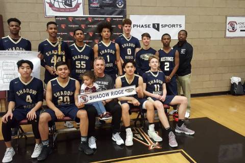Shadow Ridge basketball players pose with their trophy at the Tri-State Invitational on Frid ...