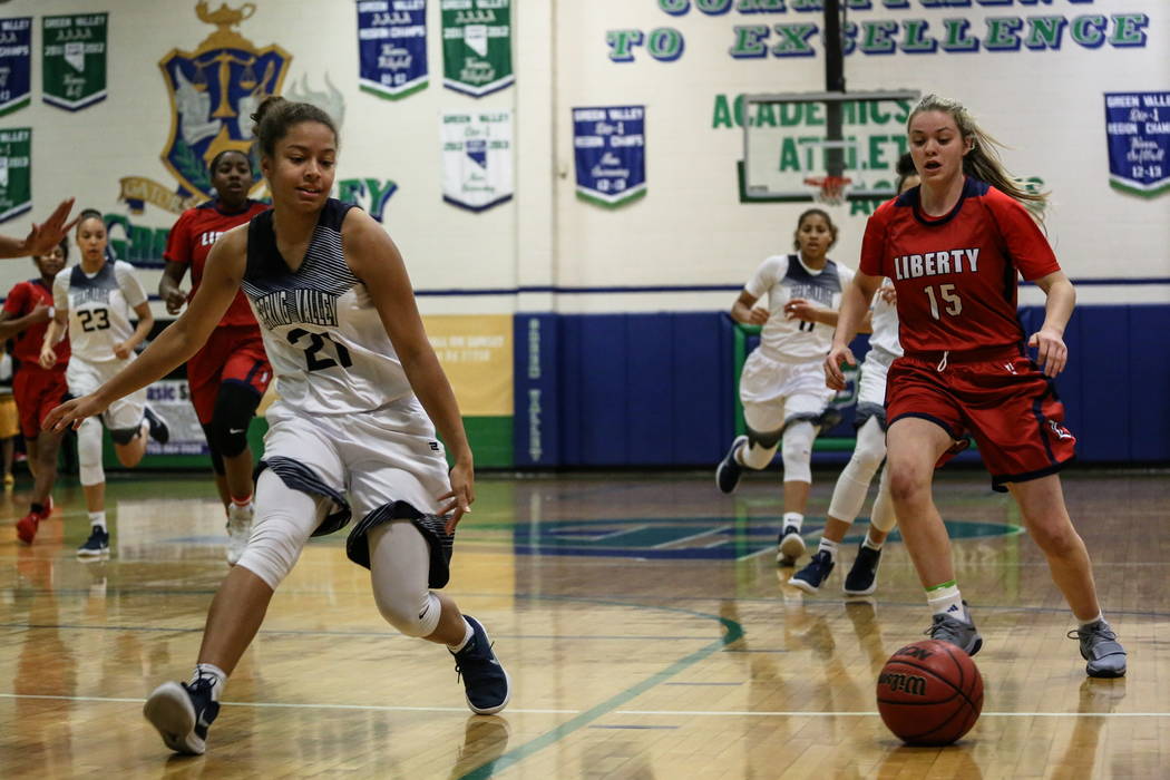 Spring Valley’s Ella Zanders (21) and Liberty’s London Pavlica (15) eye a loose ...