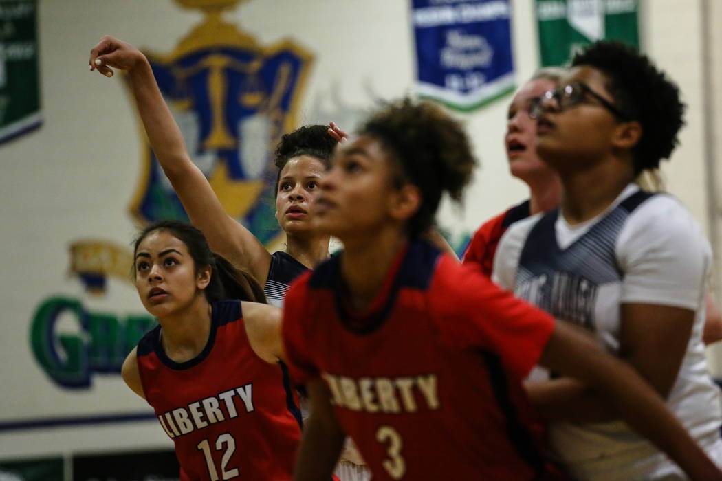 Spring Valley’s Essence Booker (3), second from left, shoots a free-throw during the ...
