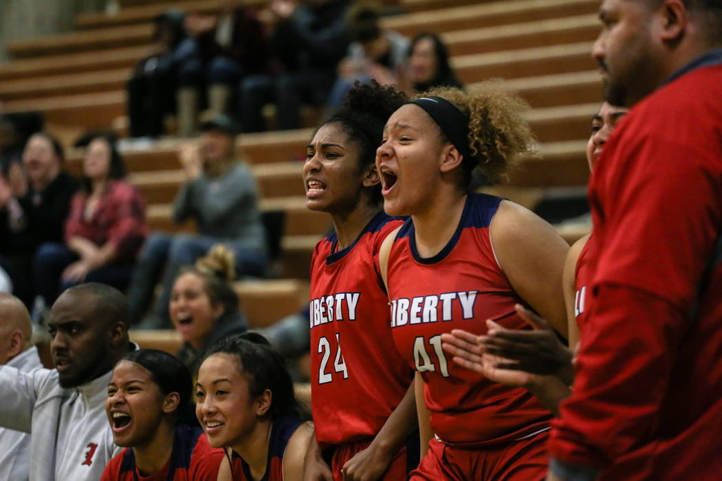 Liberty’s Trinity Vasquez (24) and Alexss Parker (41) cheer during the fourth quarter ...