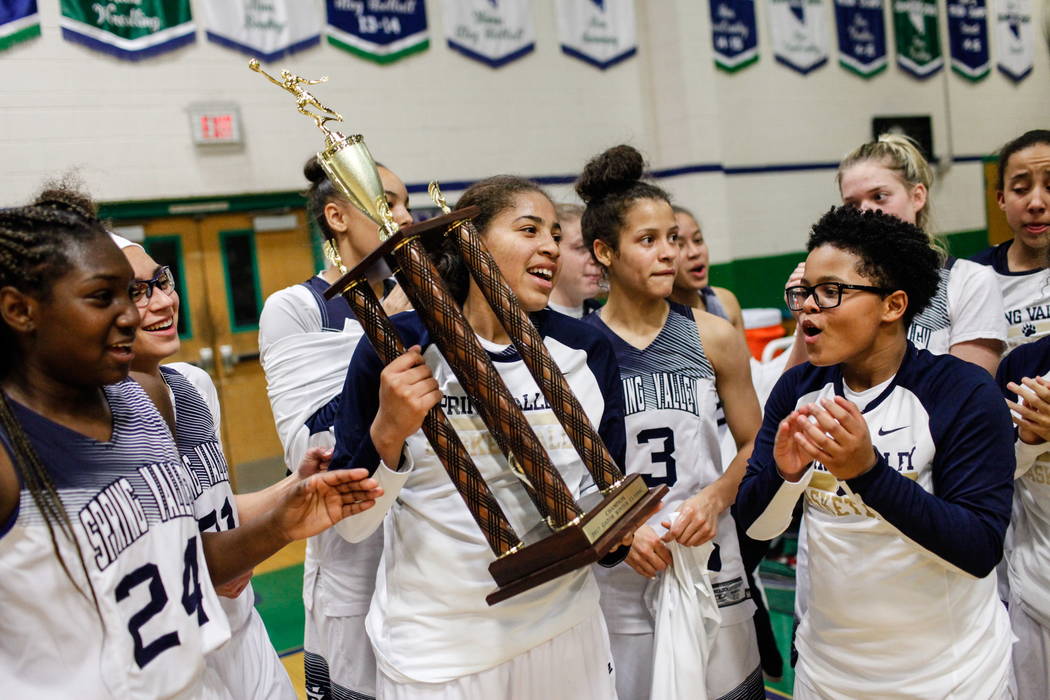 Spring Valley’s Kayla Harris (11) holds the championship trophy after defeating Liber ...