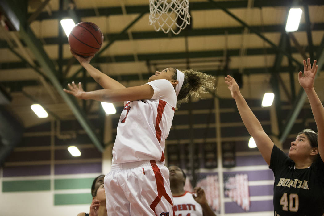 Liberty’s Rae Burrell (0) goes up for a shot against Bonita Vista in the girl’s ...