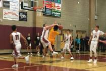 Clark’s Frankie Collins goes up for a shot defended by Desert Oasis’ Kaydyn Koch ...