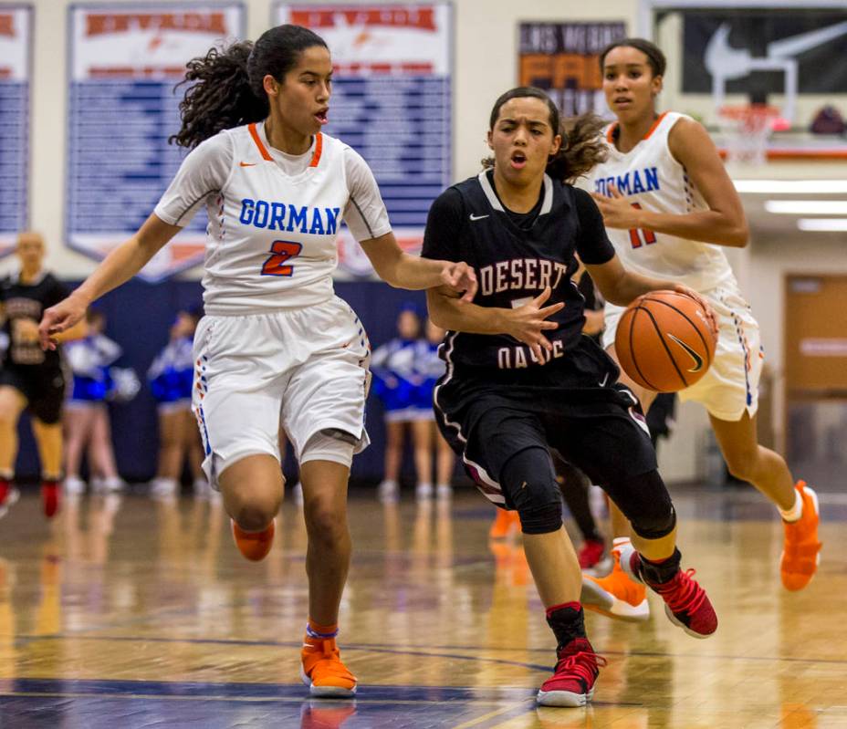 Desert Oasis’ Eliyjah Pricebrooks attempts to dribble around Bishop Gorman’s Sha ...