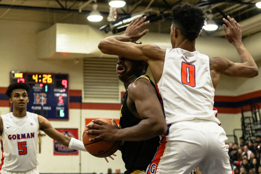 Clark Chargers’ Antwon Jackson (23) is guarded by Bishop Gorman’s Isaiah Cottrel ...