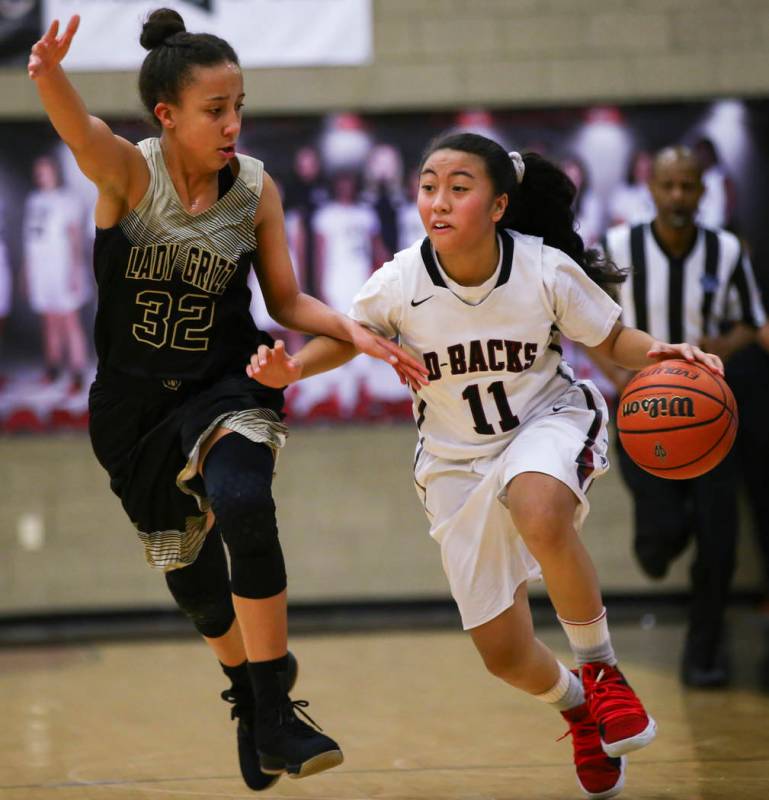 Desert Oasis’ Kalena Halunajan (11) brings the ball up court against Spring Valley&#82 ...